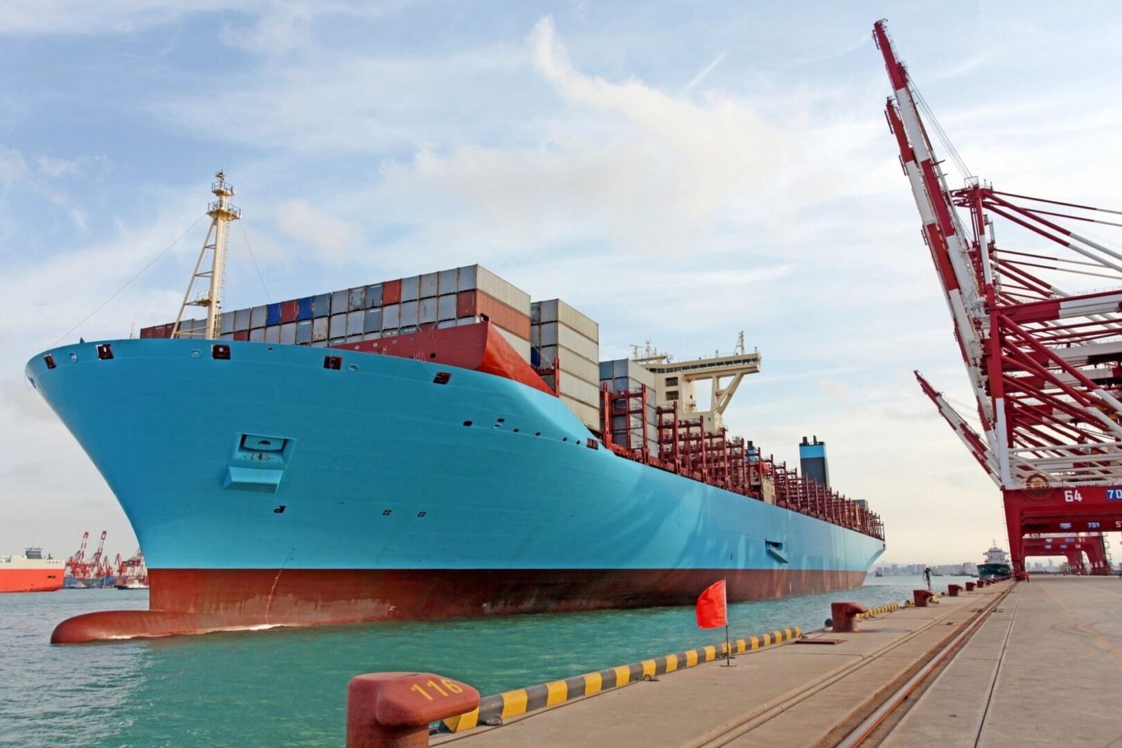 A large blue ship is docked at the dock.